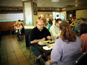 A family eating happily at Michigan Diner.